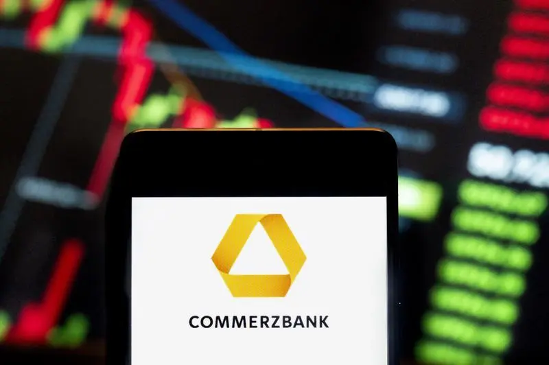 June 21, 2024, China: In this photo illustration, the German banking and financial services company Commerzbank (ETR: CBK) logo seen displayed on a smartphone with an economic stock exchange index graph in the background.,Image: 889283346, License: Rights-managed, Restrictions: , Model Release: no, Credit line: Budrul Chukrut / Zuma Press / ContactoPhoto