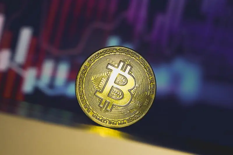 July 3, 2024, Paraguay: In this photo illustration, a Bitcoin is seen on the table with a stock market graph in the background.,Image: 887016018, License: Rights-managed, Restrictions: , Model Release: no, Credit line: Jaque Silva / Zuma Press / ContactoPhoto