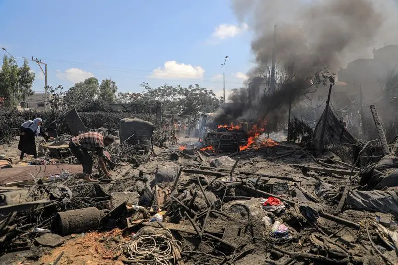 GAZA, July 13, 2024  -- This photo taken on July 13, 2024 shows destroyed buildings and vehicles following an Israeli airstrike in the Mawasi area of the southern Gaza Strip city of Khan Younis. At least 71 Palestinians were killed and 289 others injured on Saturday by an Israeli airstrike that attacked tents of displaced people in the Mawasi area of the Khan Younis city in the south of Gaza, the Gaza health authorities said.,Image: 889455340, License: Rights-managed, Restrictions: , Model Release: no, Credit line: Rizek Abdeljawad / Xinhua News / ContactoPhoto