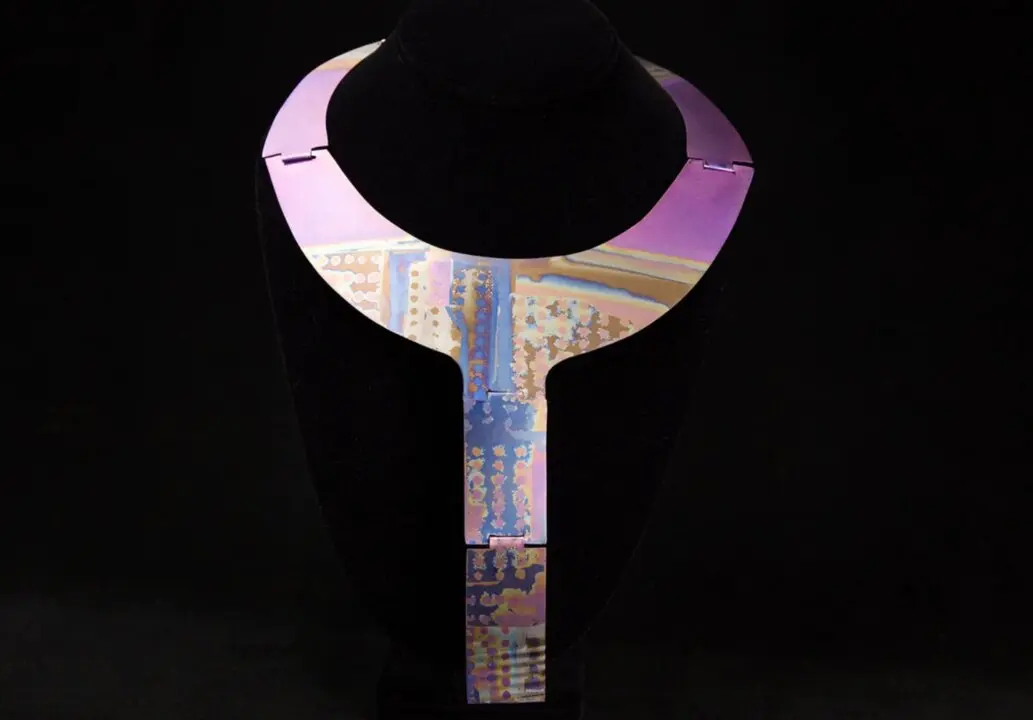 This undated photo provided by the Oakland Museum of California Thursday, Oct. 30, 2025, shows the Slot-Hinged Titanium Neckpiece by Florence Resnikoff at the Oakland Museum of California, in Oakland, Calif. (Leopold Macaya/Oakland Museum of California via AP)