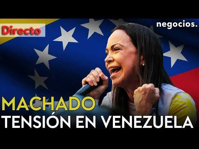 María Corina Machado en rueda de prensa, con bandera venezolana de fondo y el video destacado en la esquina inferior.<br>                        <br>                        <br>                        <br>                      
