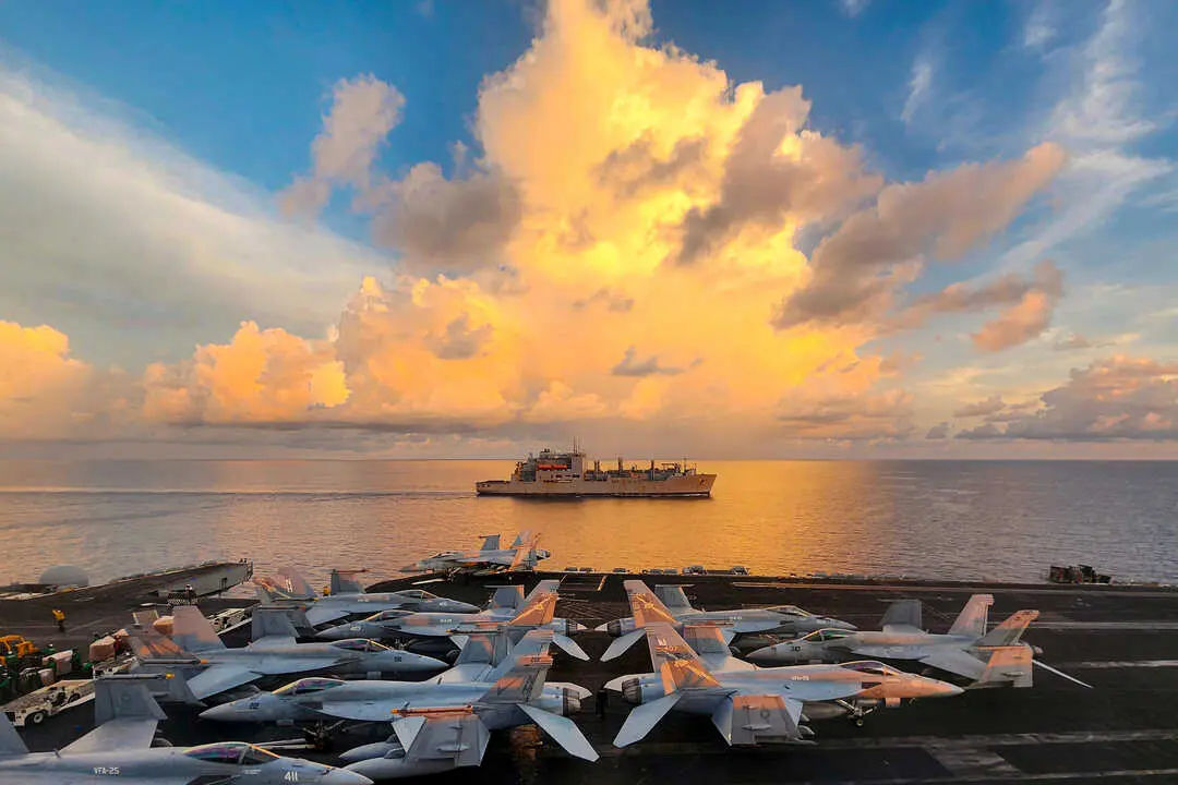 SOUTH CHINA SEA (May 14, 2024) The Lewis and Clark-class dry cargo ship USNS Wally Schirra (T-AKE 8) sails alongside the Nimitz-class aircraft carrier USS Theodore Roosevelt (CVN 71) during a replenishment-at-sea, May 14, 2024. Theodore Roosevelt, flagship of Carrier Strike Group Nine, is underway conducting routine operations in the U.S. 7th Fleet area of operations. U.S. 7th Fleet is the U.S. Navy&rsquo;s largest forward-deployed numbered fleet, and routinely interacts and operates with allies and partners in preserving a free and open Indo-Pacific region. (U.S. Navy photo by Mass Communication Specialist 2nd Class Christopher Crawford)