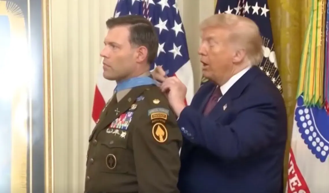 Trump entregando la medalla al militar.