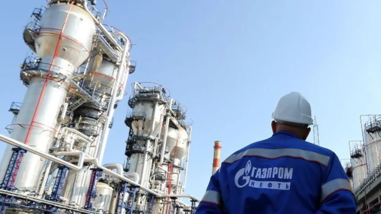 A Gazprom employee stands near to the new bitumen processor at the OAO Gazprom Neft oil refinery in Moscow, Russia, on Thursday, Sept. 20, 2012. OAO Gazprom Neft, the oil arm of Russia's state-run natural-gas producer, started operating a 3.2 billion-ruble ($100 million) bitumen processor at its Moscow refinery this month as it seeks to reduce pollution. Photographer: Andrey Rudakov/Bloomberg