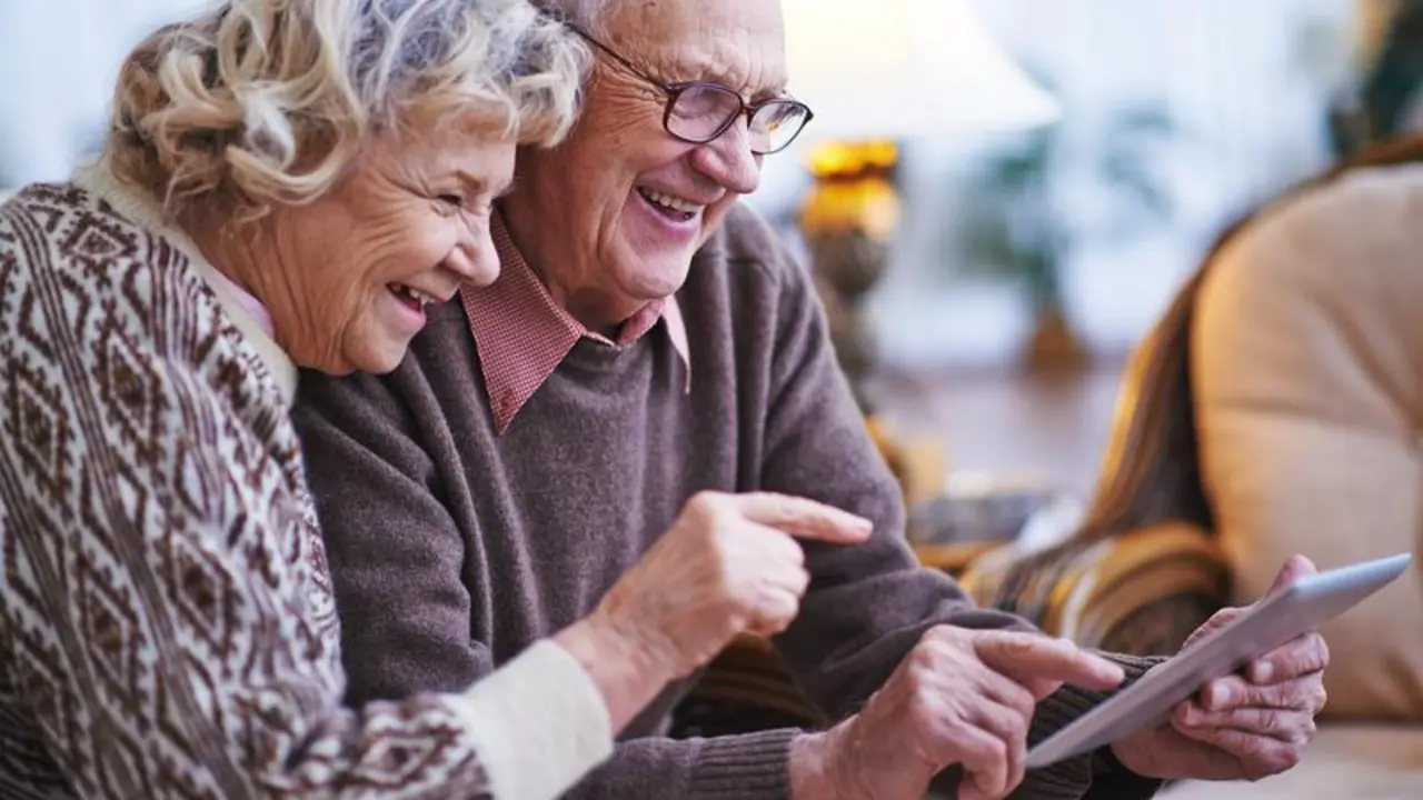 Happy seniors networking together at home