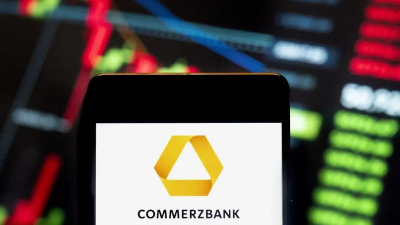 June 21, 2024, China: In this photo illustration, the German banking and financial services company Commerzbank (ETR: CBK) logo seen displayed on a smartphone with an economic stock exchange index graph in the background.,Image: 889283346, License: Rights-managed, Restrictions: , Model Release: no, Credit line: Budrul Chukrut / Zuma Press / ContactoPhoto