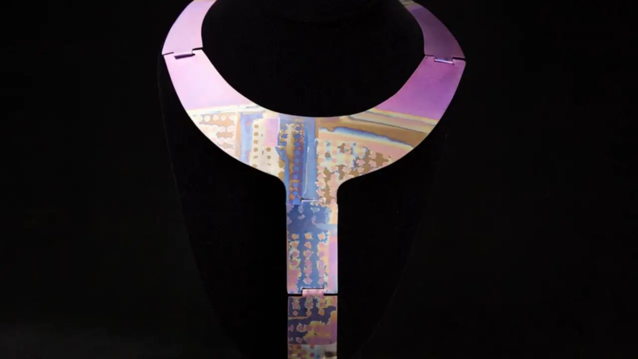 This undated photo provided by the Oakland Museum of California Thursday, Oct. 30, 2025, shows the Slot-Hinged Titanium Neckpiece by Florence Resnikoff at the Oakland Museum of California, in Oakland, Calif. (Leopold Macaya/Oakland Museum of California via AP)