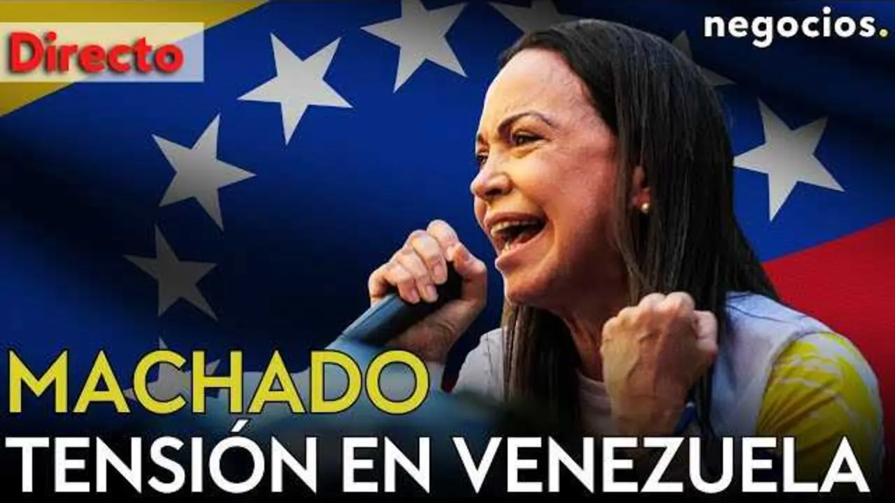 María Corina Machado en rueda de prensa, con bandera venezolana de fondo y el video destacado en la esquina inferior.<br>                        <br>                        <br>                        <br>                      