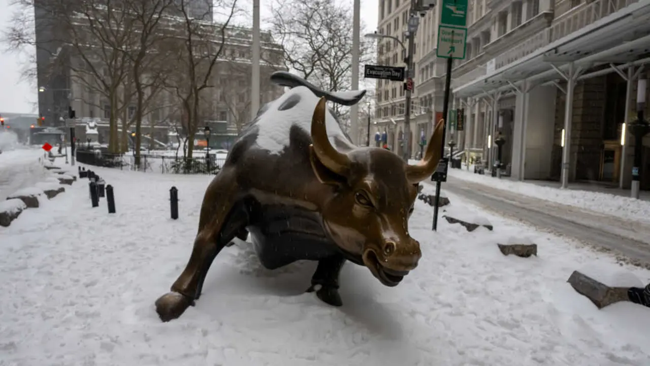 The Wall Street Bull seen as snow falls in the Financial District on January 25, 2026 in New York City.
