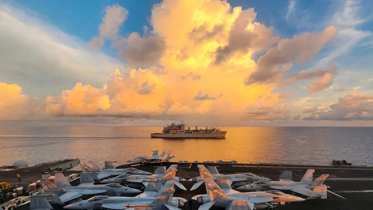 SOUTH CHINA SEA (May 14, 2024) The Lewis and Clark-class dry cargo ship USNS Wally Schirra (T-AKE 8) sails alongside the Nimitz-class aircraft carrier USS Theodore Roosevelt (CVN 71) during a replenishment-at-sea, May 14, 2024. Theodore Roosevelt, flagship of Carrier Strike Group Nine, is underway conducting routine operations in the U.S. 7th Fleet area of operations. U.S. 7th Fleet is the U.S. Navy&rsquo;s largest forward-deployed numbered fleet, and routinely interacts and operates with allies and partners in preserving a free and open Indo-Pacific region. (U.S. Navy photo by Mass Communication Specialist 2nd Class Christopher Crawford)