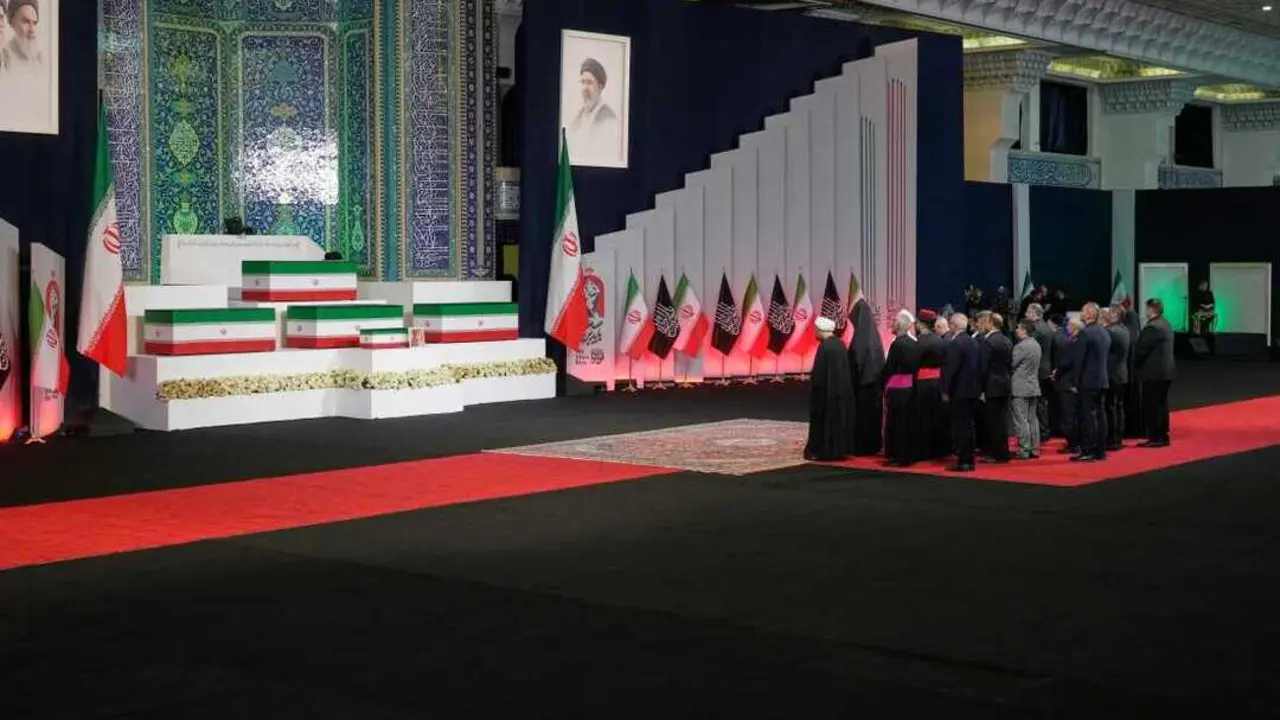 Iranian religious leaders and other mourners pay their respects before the coffins of slain Iranian Supreme Leader Ayatollah Ali Khamenei and members of his family during a viewing ceremony ahead of the dayslong funeral ceremonies at the Imam Khomeini Mosalla Grand Mosque in Tehran, Iran, Friday, July 3, 2026. (AP Photo/Vahid Salemi)